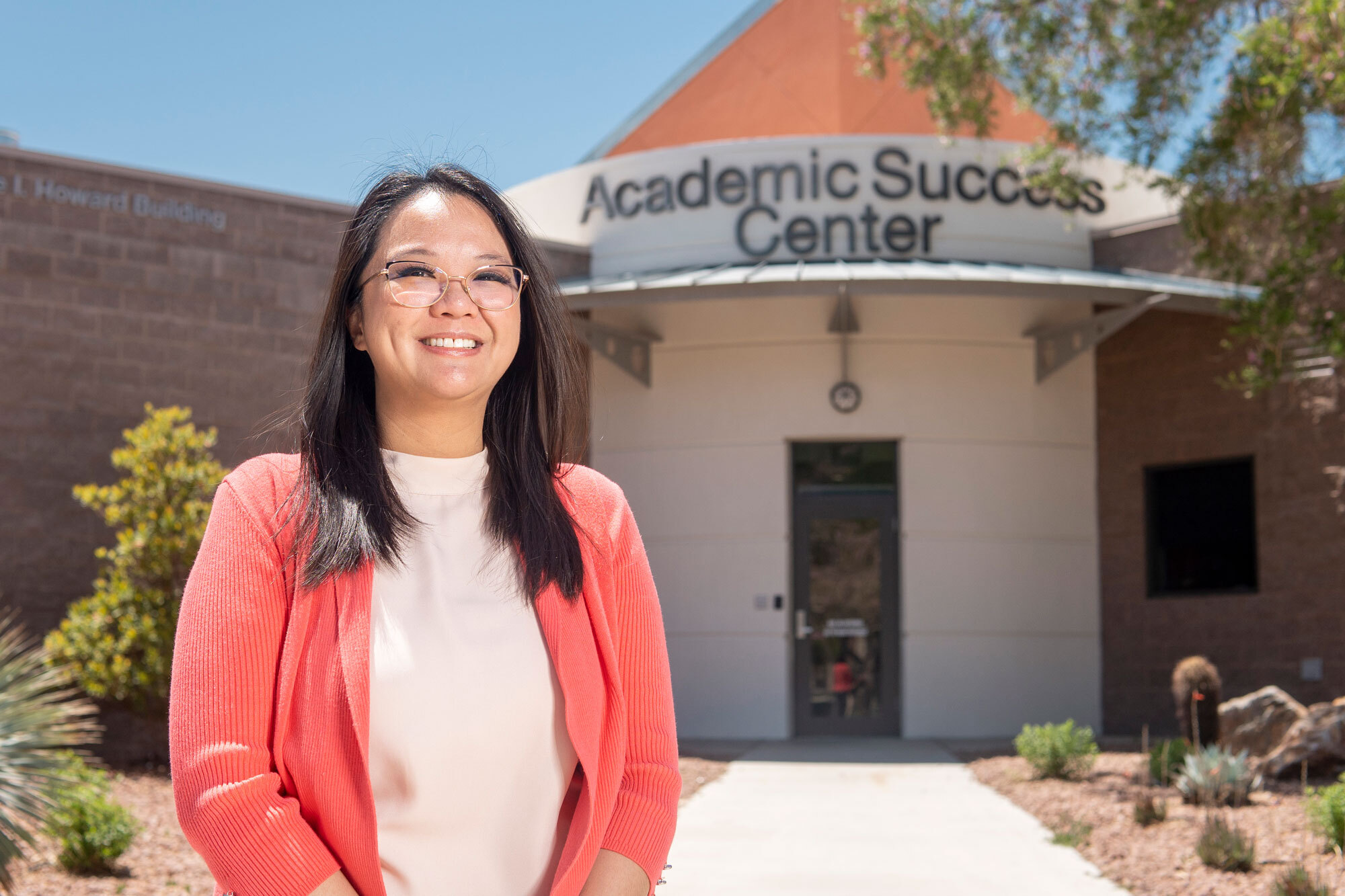 Person standing in front of building that says Academic Success Center