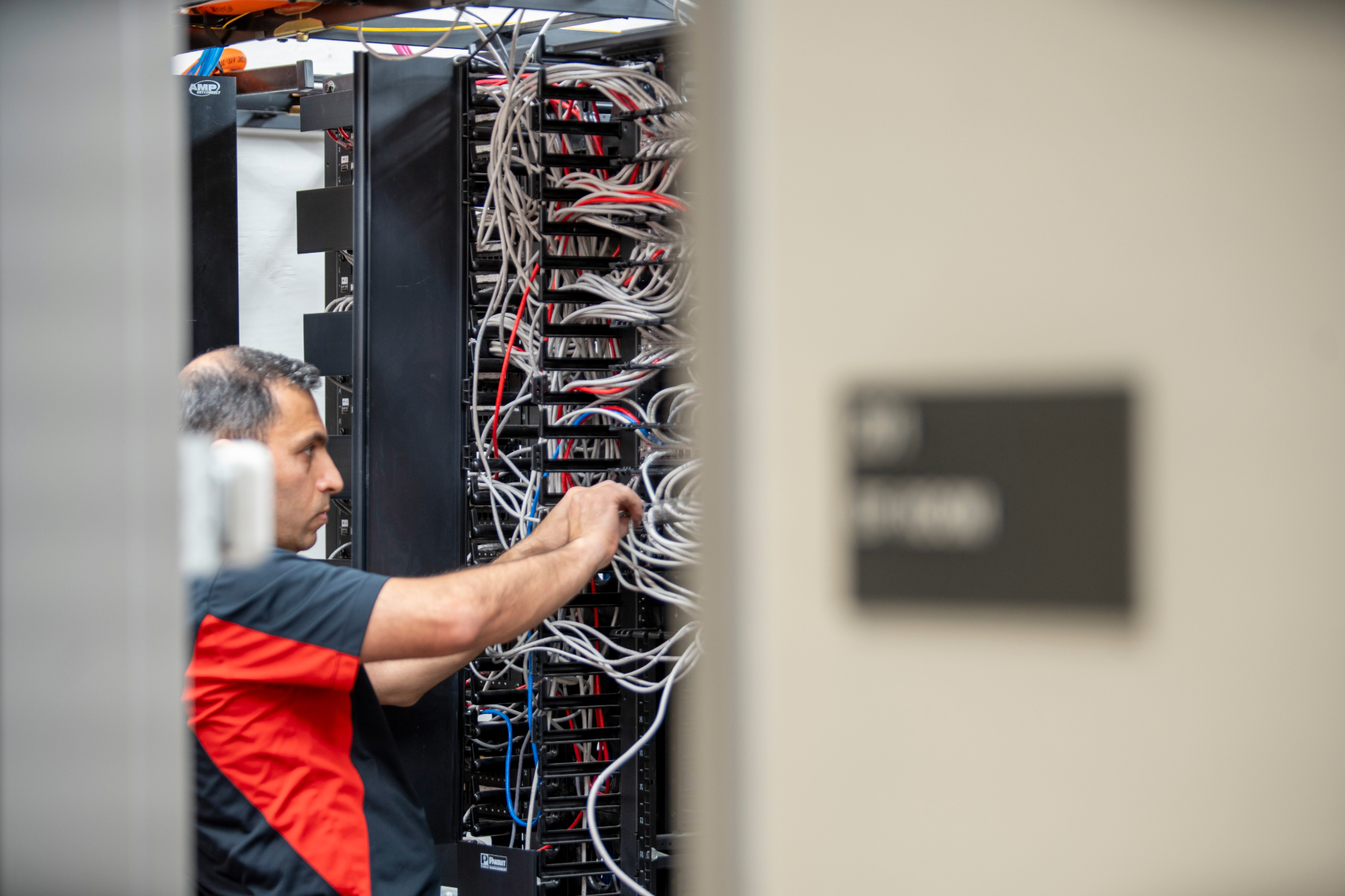 Network team installing cables as part of the network modernization project. 