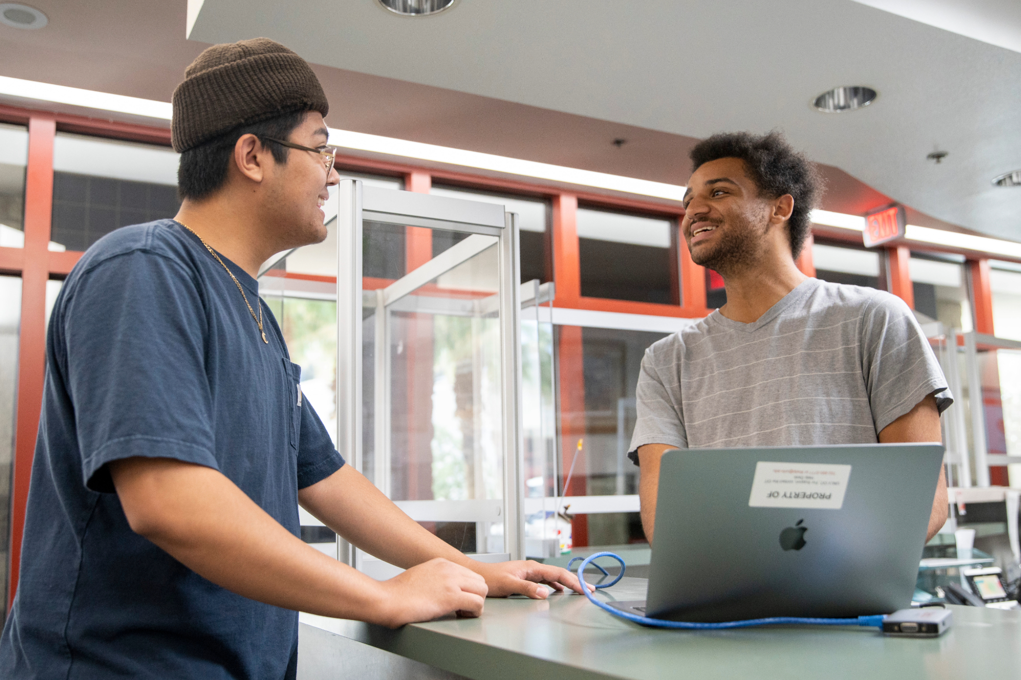 Person helping customer at the Technology Loan Program office. 