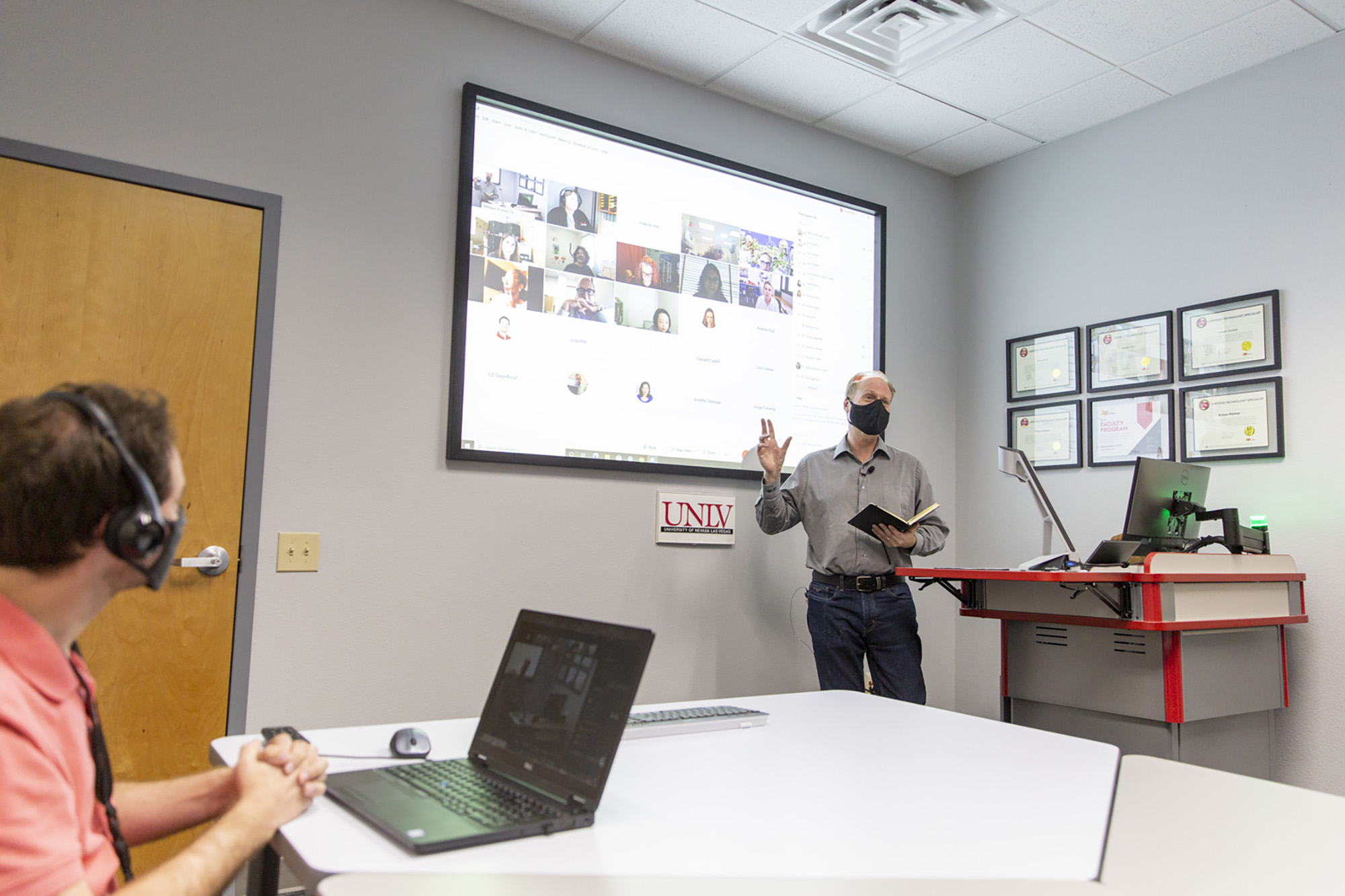 An instructor leads a class from the lectern.