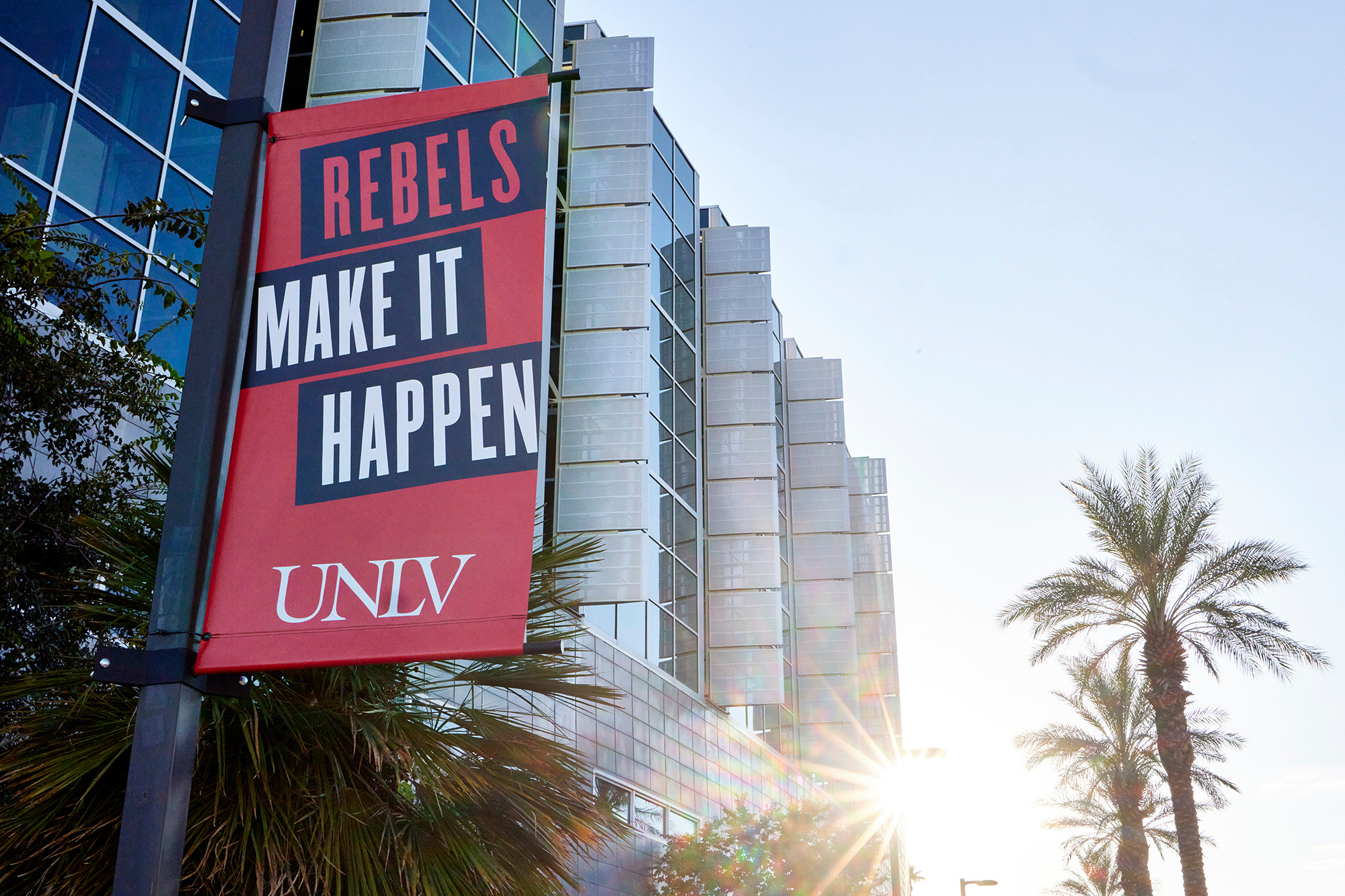 Close shot of a 'Rebels Make it Happen' banner on campus.