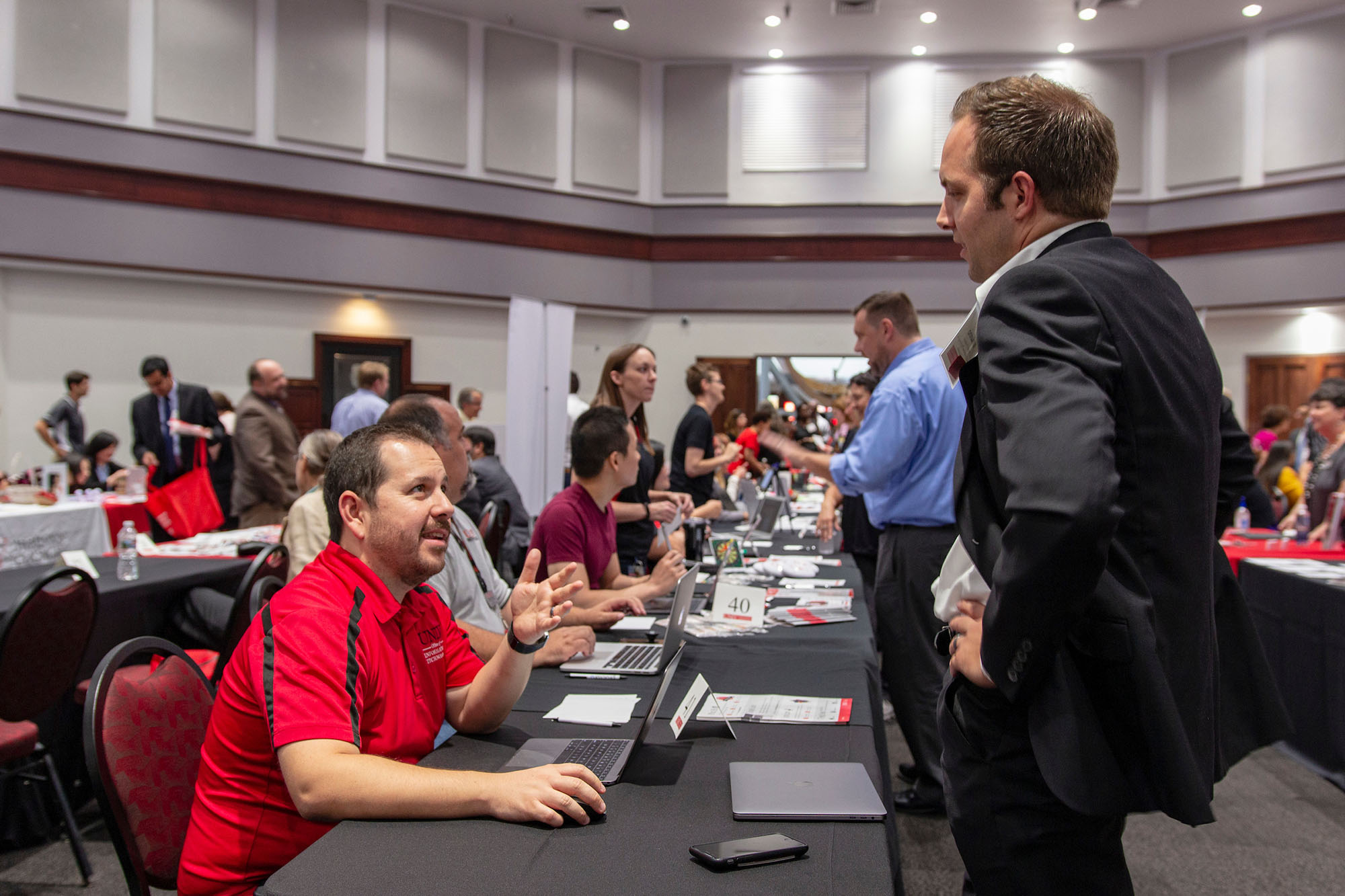 An O-I-T staff member helps a faculty member at orientation.