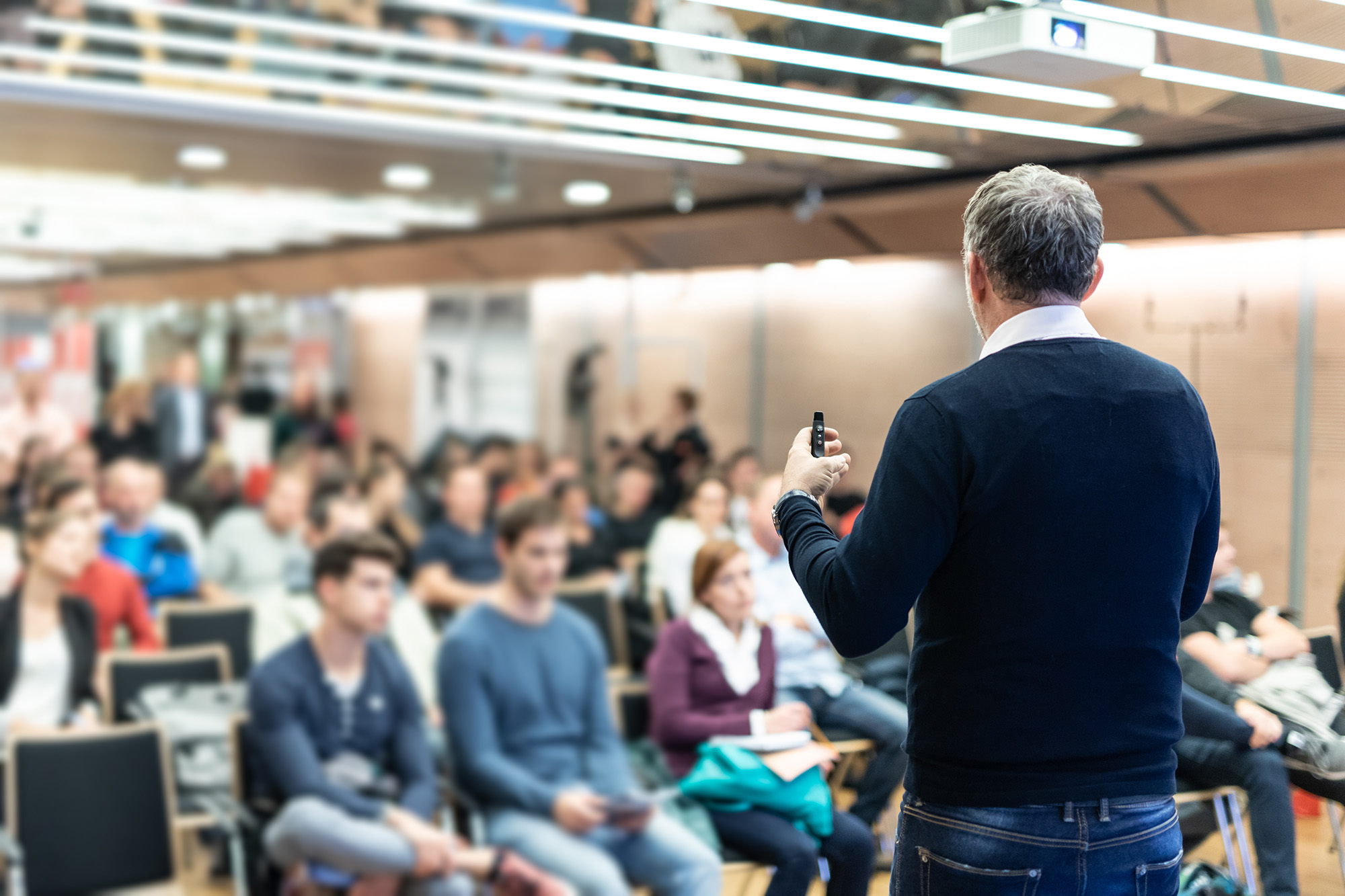University professor giving lecture in college hall.