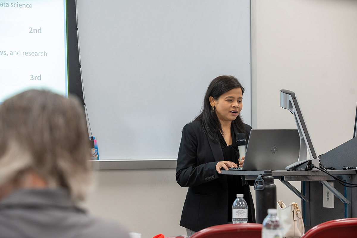 An instructor leads a workshop from the lectern.