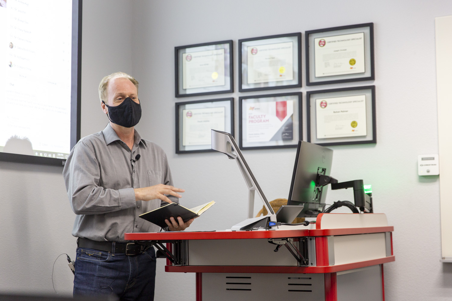 An instructor leads a class from the lectern.