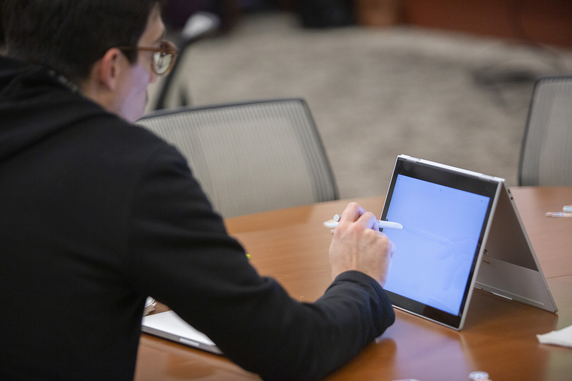 A male staff member uses a tablet .