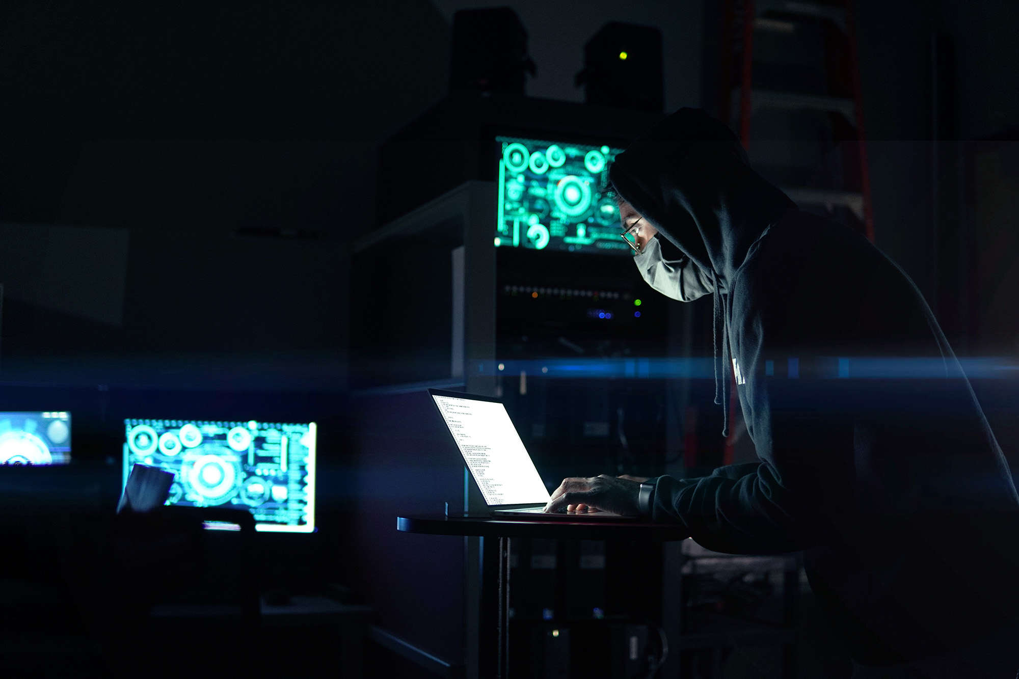 Person using laptop computer in dark room