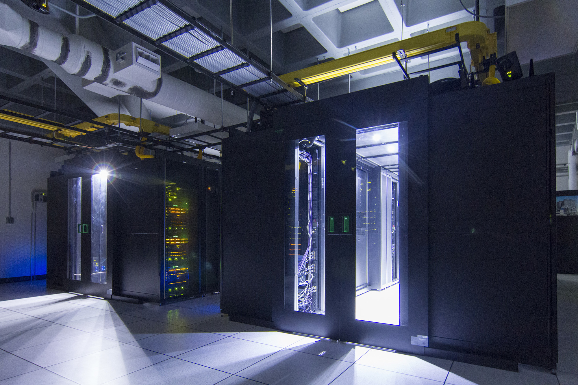 U-N-L-V data center illuminated by only network equipment.