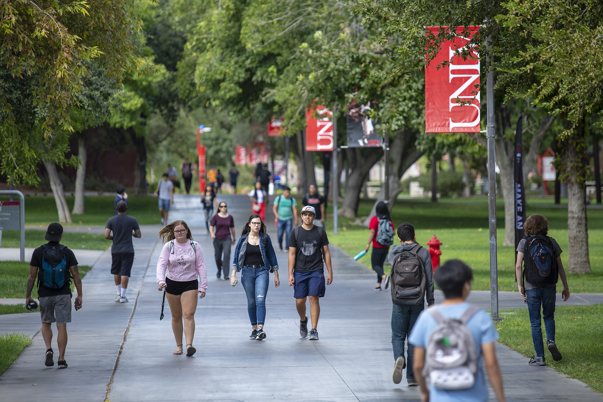 Students stroll a busy university corridor.