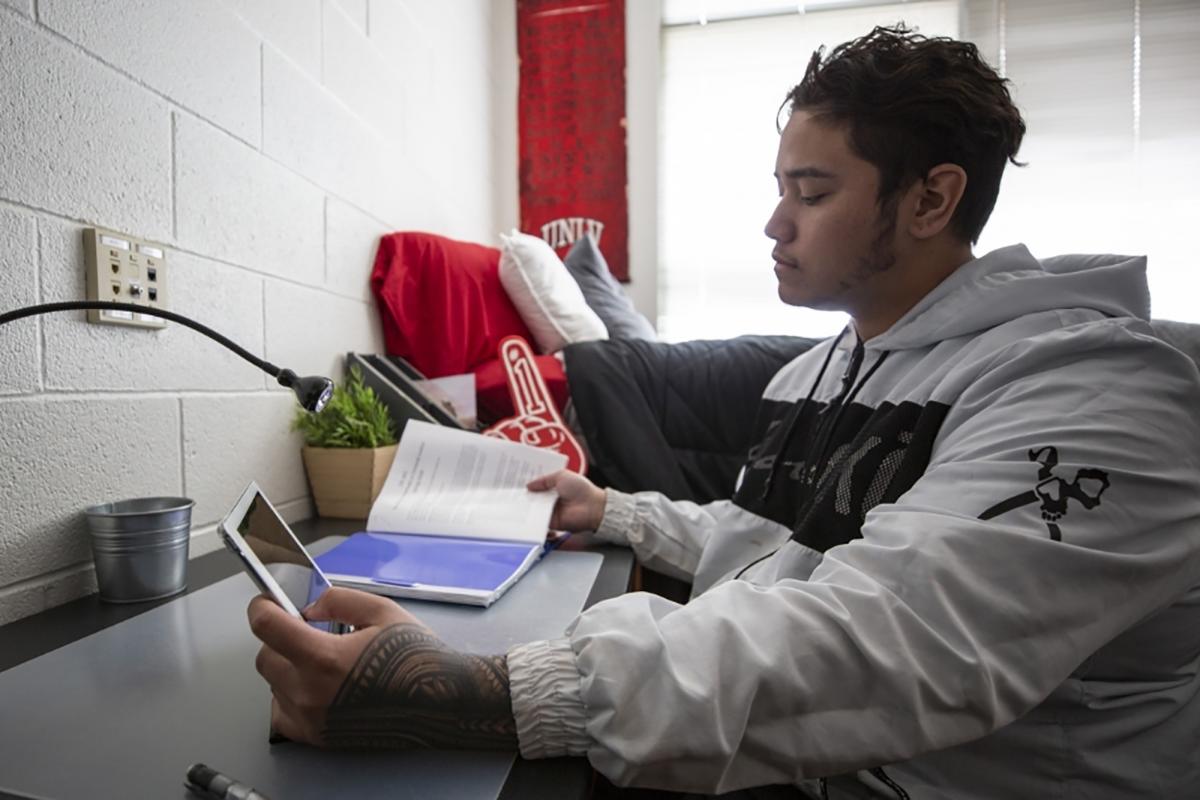 A student studies in a U-N-L-V dorm room.