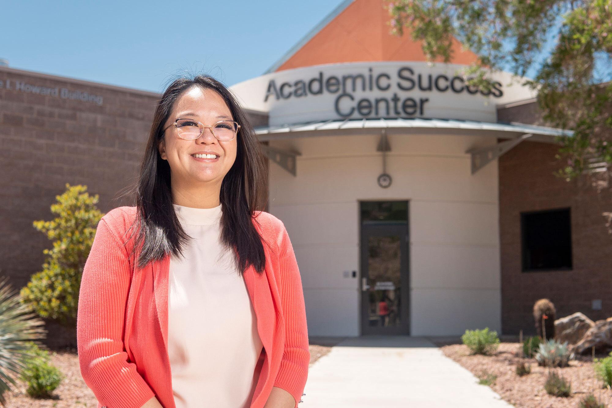  Person standing in front of building that says Academic Success Center