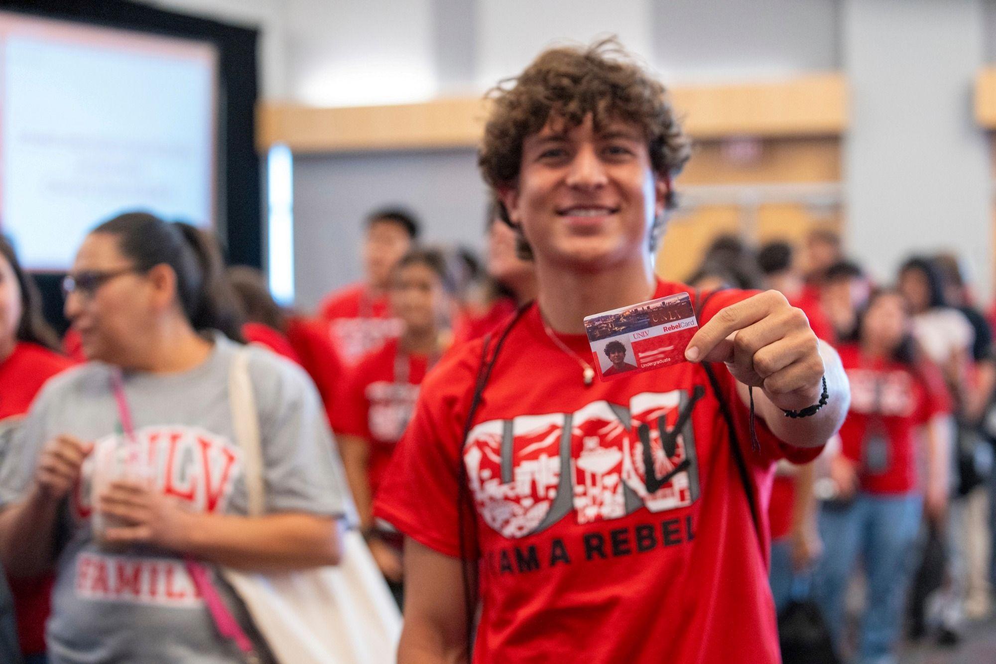 Person holding their RebelCard campus ID