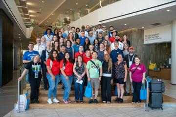 Tour attendees on the steps of Hospitality Hall.