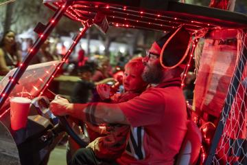 Person dressed up as a pirate driving a golf cart.