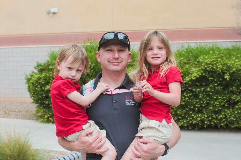 Person posing for a photo with their children