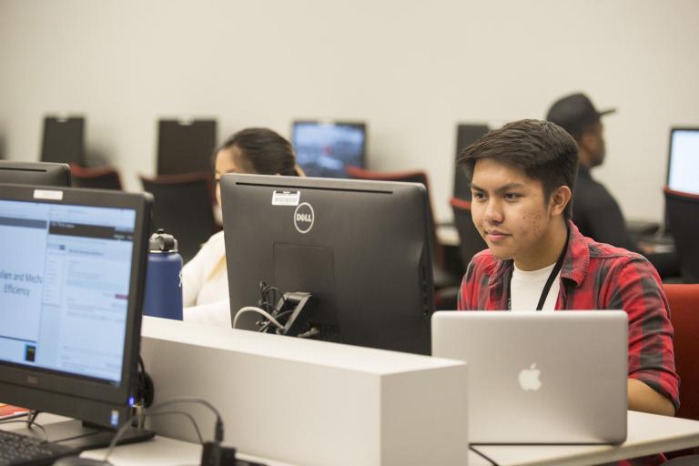 A student working at a U-N-L-V computer lab using their laptop.