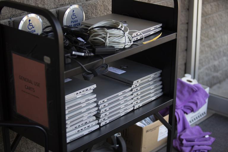 A cart full with loaner laptops.