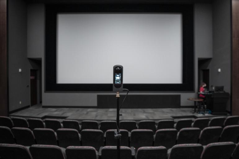 A camera pointing at projection screen in a classroom