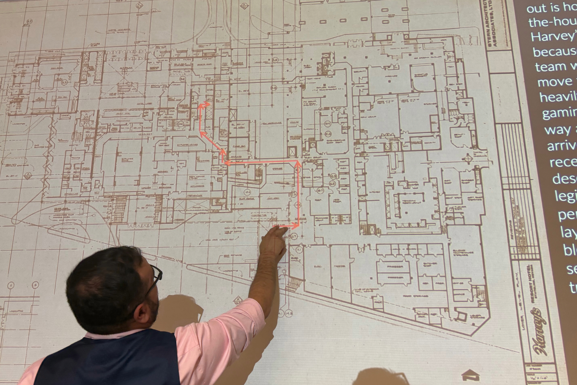 Student analyzing architecture plans projected on a board. 