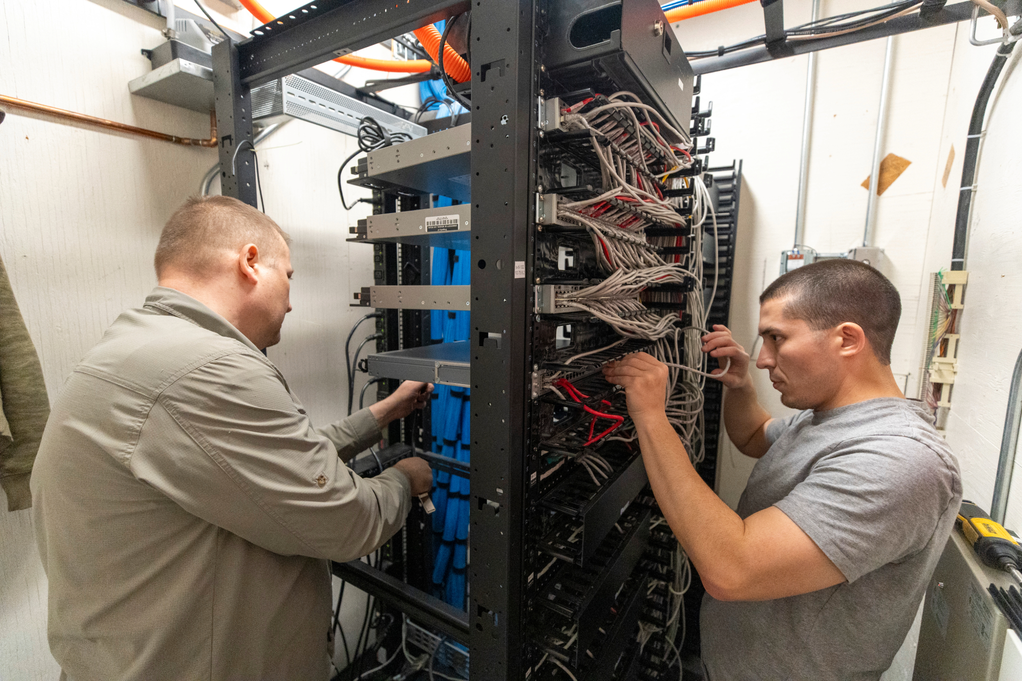 Network team installing cables for network modernization project.